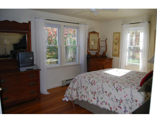 170 Westboro Road Upton, MA 01568 - Photo 10 of 15 a bedroom with a bed a dresser a mirror and window