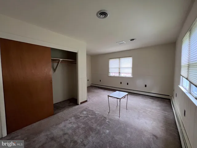 a room with a window and a wooden floor