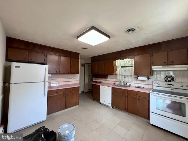 a kitchen with a sink a stove and refrigerator