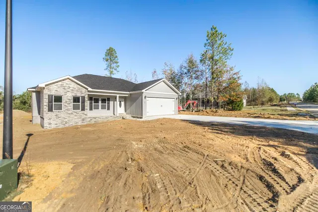 a view of house with yard and swimming pool