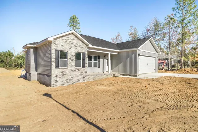 a view of a house with snow on the road
