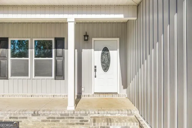 a view of a door of a house with a porch