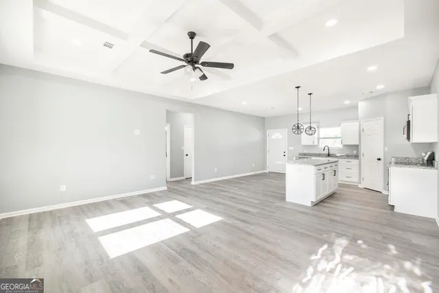 a view of kitchen with sink and wooden floor