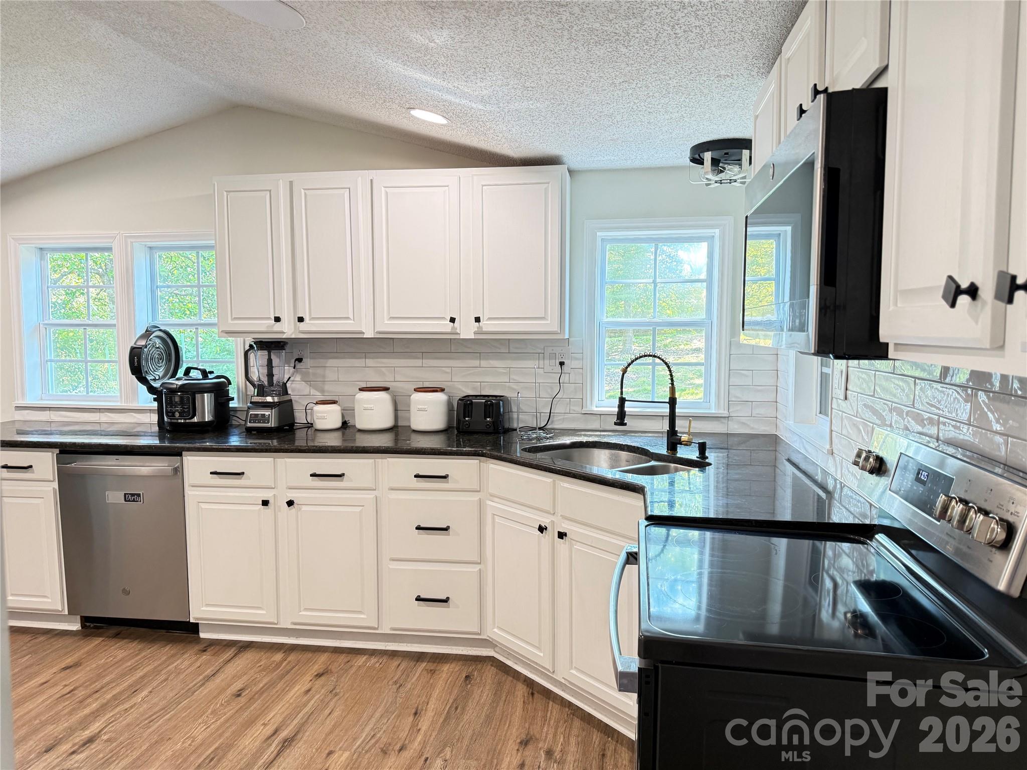 1442 Lee Pearson Road Granite Falls, NC 28630 - Photo 11 of 40 a kitchen with a sink stove and cabinets