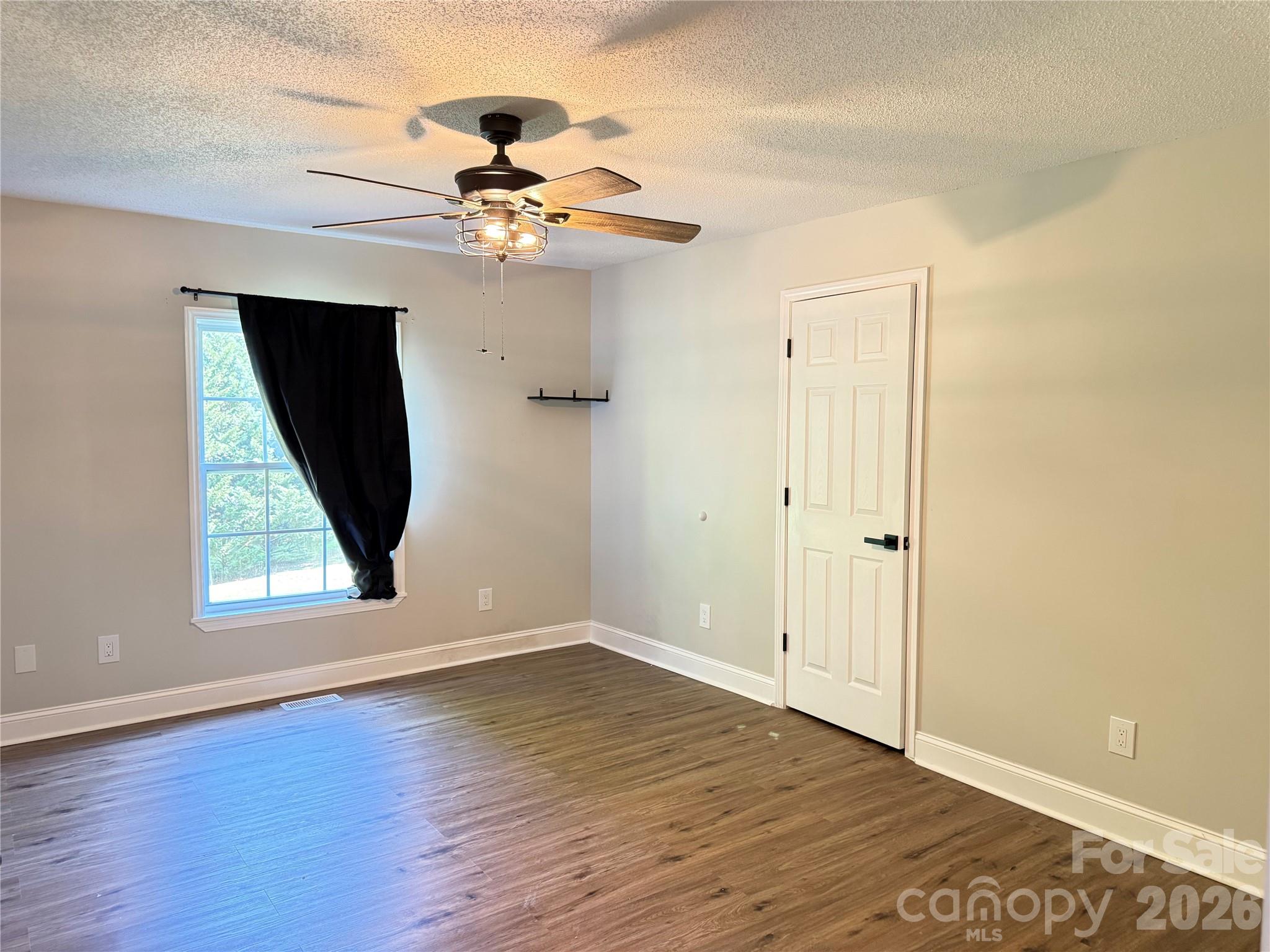 1442 Lee Pearson Road Granite Falls, NC 28630 - Photo 17 of 40 a view of an empty room with wooden floor and a window