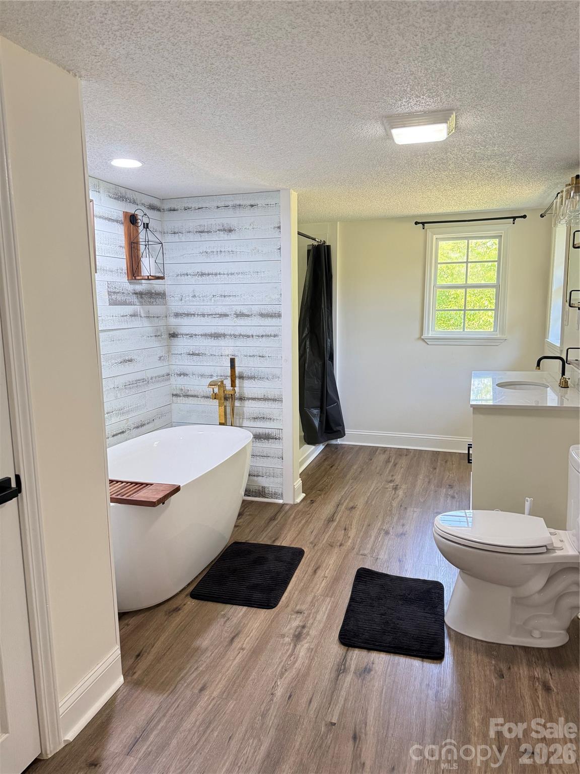 1442 Lee Pearson Road Granite Falls, NC 28630 - Photo 18 of 40 a bathroom with a granite countertop toilet sink and mirror