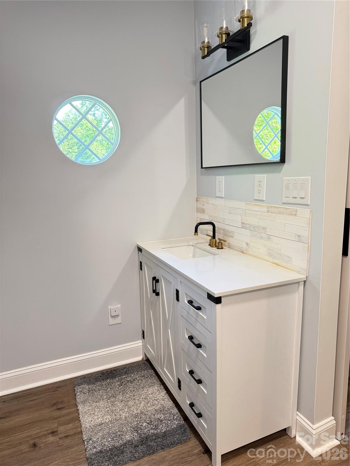 1442 Lee Pearson Road Granite Falls, NC 28630 - Photo 23 of 40 a bathroom with a sink mirror and vanity
