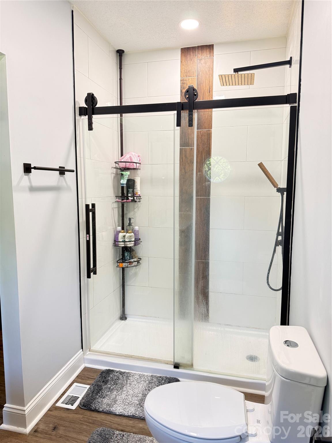 1442 Lee Pearson Road Granite Falls, NC 28630 - Photo 24 of 40 a bathroom with a toilet a sink and shower