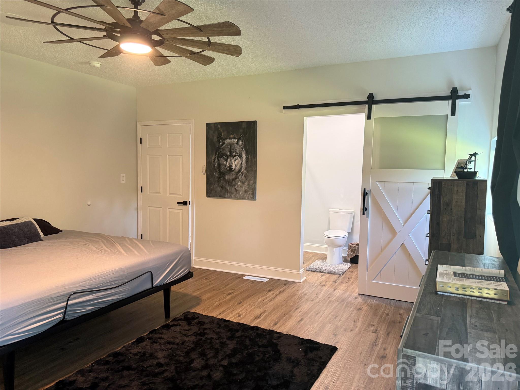 1442 Lee Pearson Road Granite Falls, NC 28630 - Photo 25 of 40 a bedroom with a bed and a chandelier
