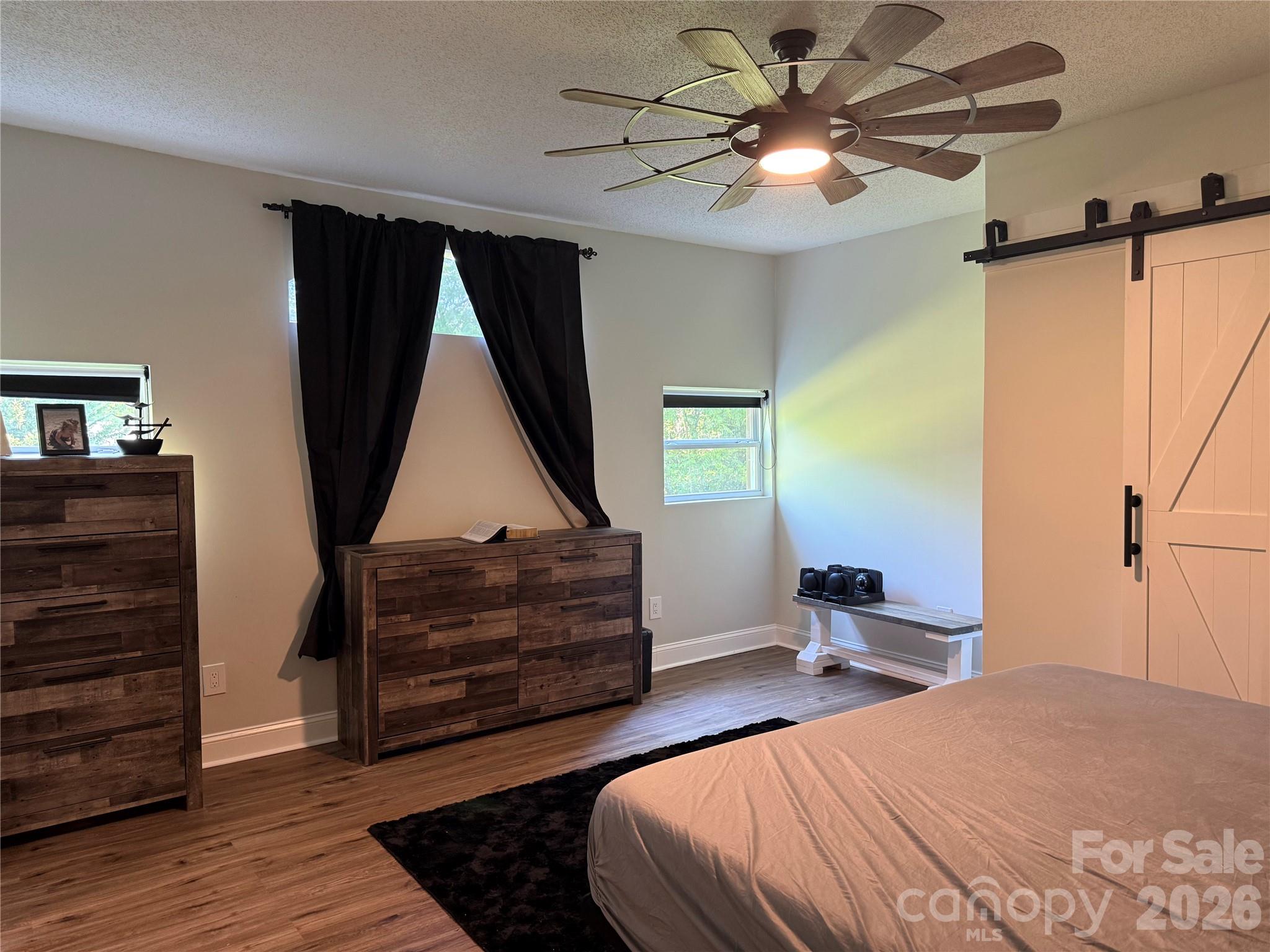 1442 Lee Pearson Road Granite Falls, NC 28630 - Photo 27 of 40 a bedroom with a bed and a chandelier