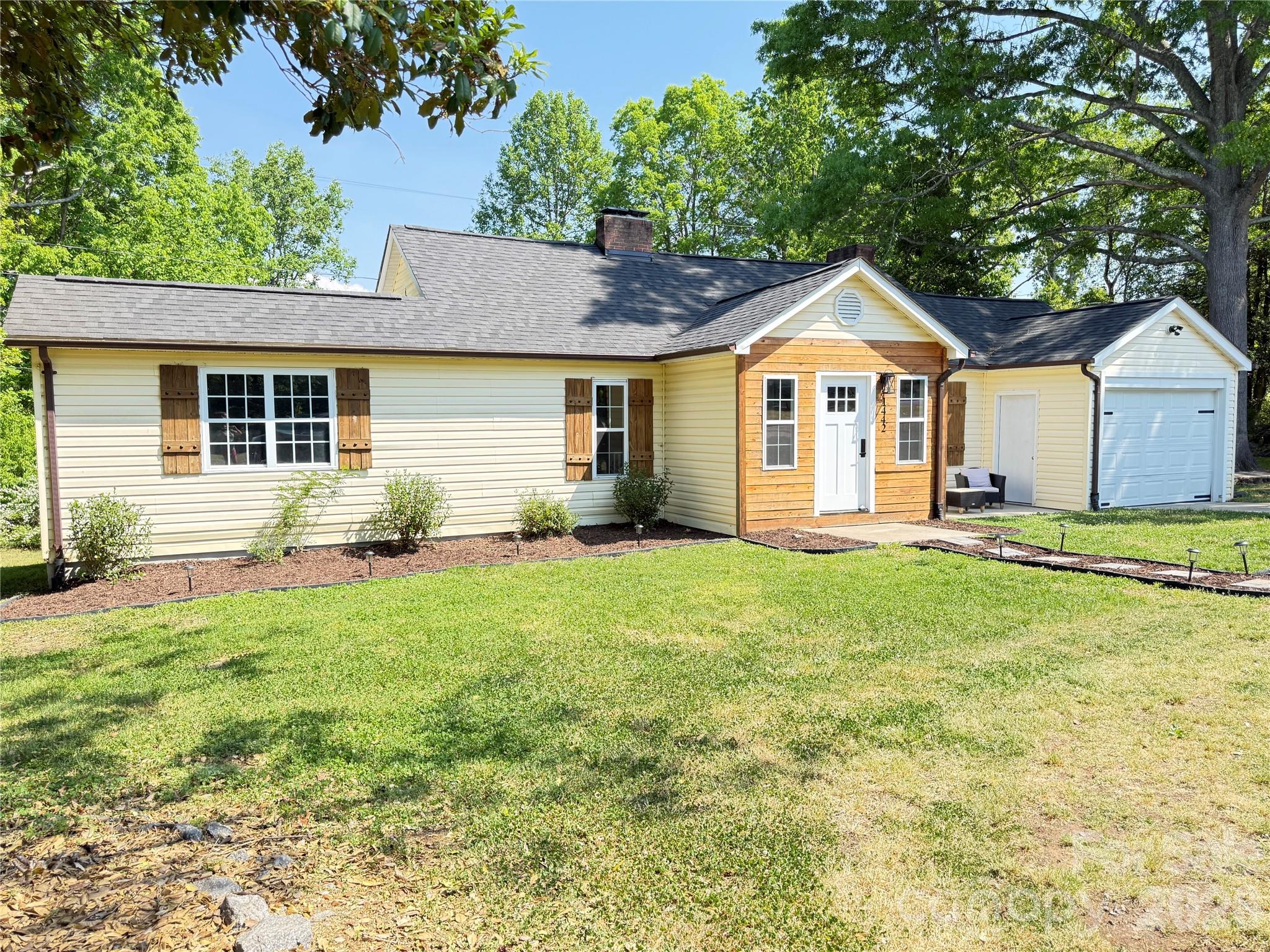 1442 Lee Pearson Road Granite Falls, NC 28630 - Photo 32 of 40 a front view of a house with a garden
