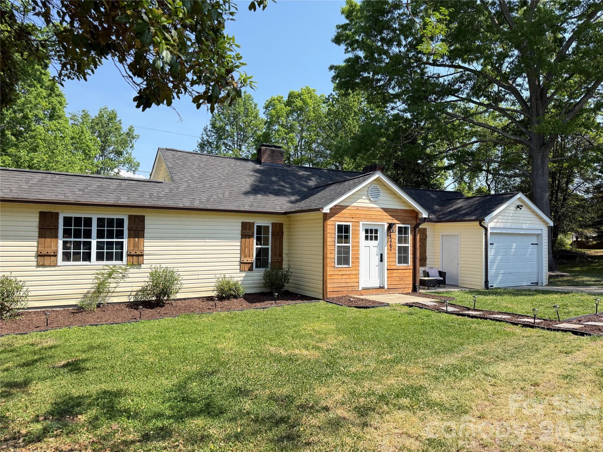 1442 Lee Pearson Road Granite Falls, NC 28630 - Photo 33 of 40 a front view of a house with yard and green space