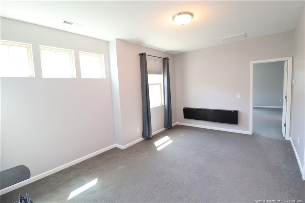 689 Wickham Ridge Road Apex, NC 27539 - Photo 19 of 37 an empty room with windows