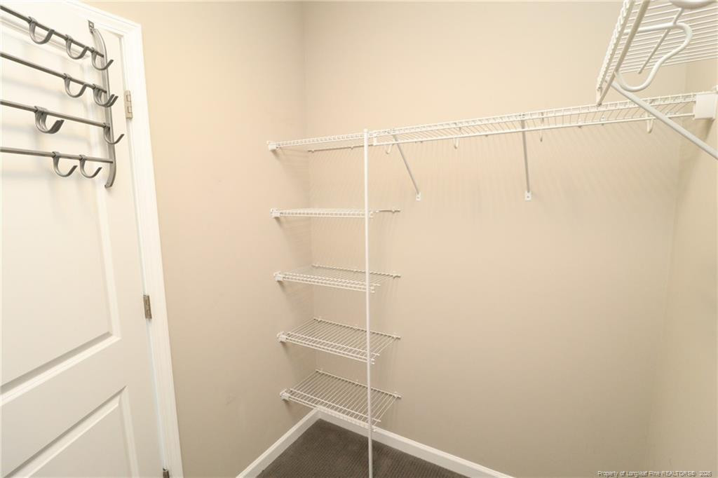 689 Wickham Ridge Road Apex, NC 27539 - Photo 29 of 37 a view of a room with racks on the wall