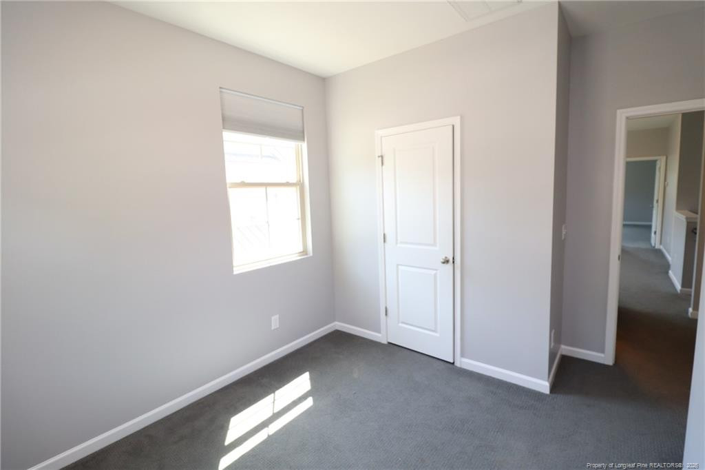 689 Wickham Ridge Road Apex, NC 27539 - Photo 31 of 37 a view of an empty room with a window