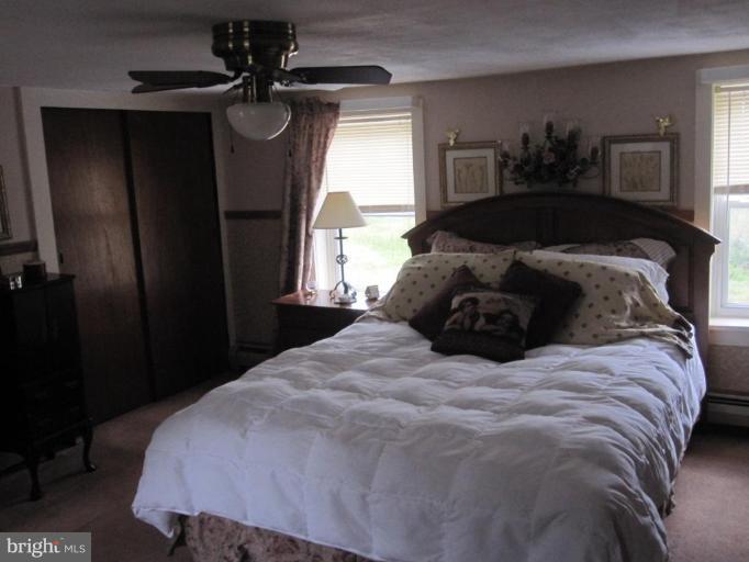 5201 Teeter Road Taneytown, MD 21787 - Photo 14 of 16 a large bed in a bedroom next to a window