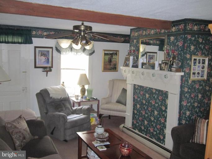 5201 Teeter Road Taneytown, MD 21787 - Photo 7 of 16 a living room with furniture and a chandelier