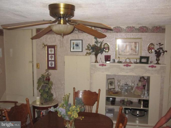 5201 Teeter Road Taneytown, MD 21787 - Photo 8 of 16 a view of a dining room with furniture and chandelier