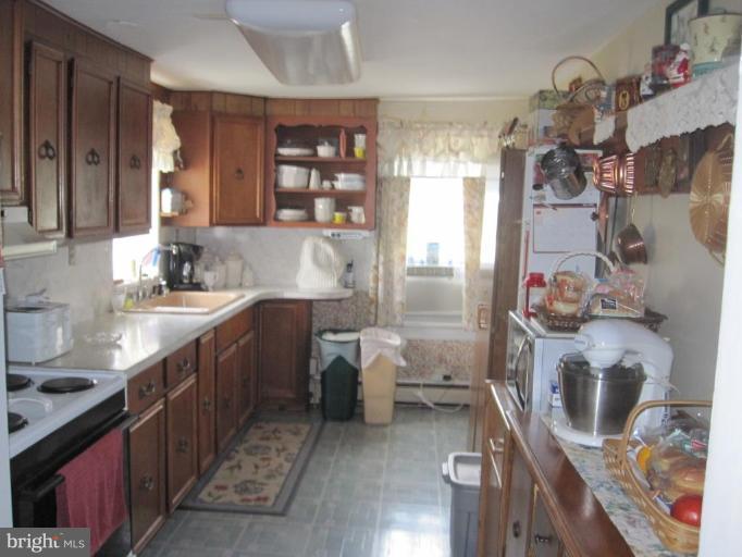 5201 Teeter Road Taneytown, MD 21787 - Photo 9 of 16 a kitchen with a sink stove and refrigerator
