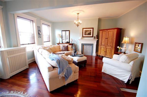 a living room with furniture fireplace and a window