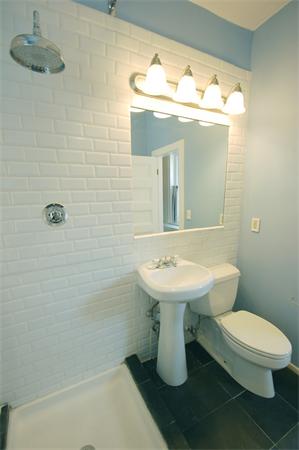 145 Charles Street, Unit 4 Boston, MA 02114 - Photo 12 of 14 a bathroom with a sink a toilet and mirror