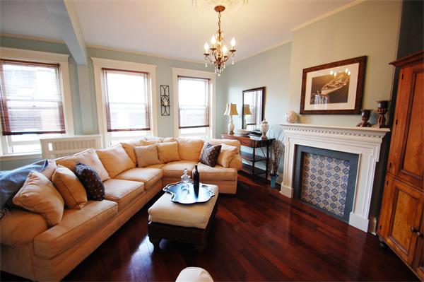 145 Charles Street, Unit 4 Boston, MA 02114 - Photo 2 of 14 a living room with furniture a fireplace and a large window