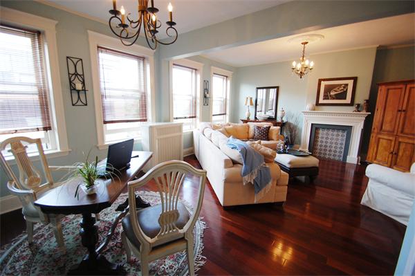 145 Charles Street, Unit 4 Boston, MA 02114 - Photo 5 of 14 a living room with furniture a fireplace and a chandelier