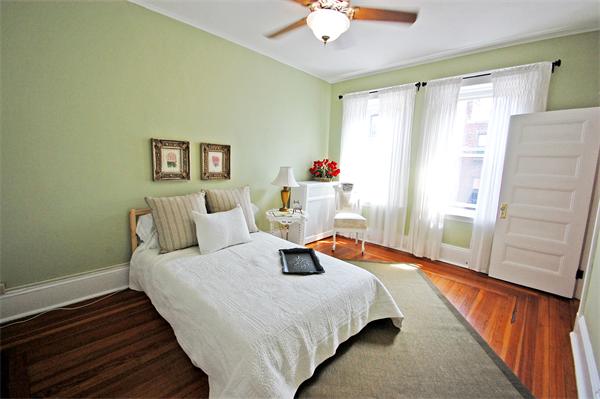 145 Charles Street, Unit 4 Boston, MA 02114 - Photo 10 of 14 a bedroom with a bed and wooden floor