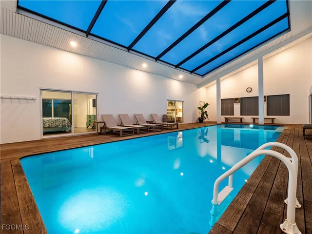 a view of a swimming pool with outdoor seating