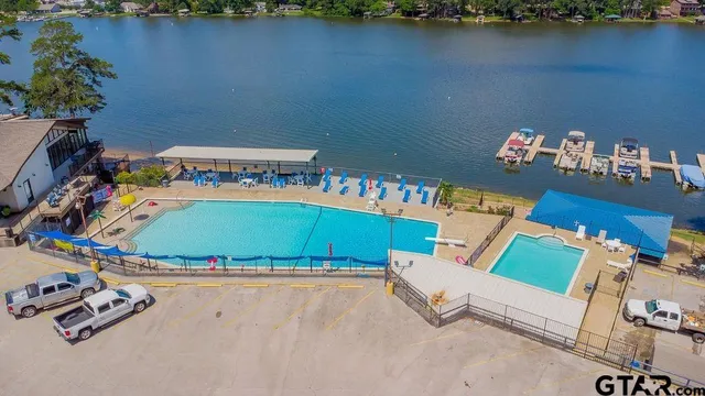 a view of a lake with lawn chairs