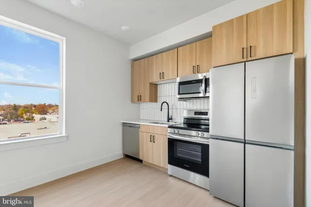 a kitchen with a refrigerator stove and microwave