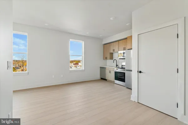 a view of a kitchen with a sink dishwasher and a refrigerator