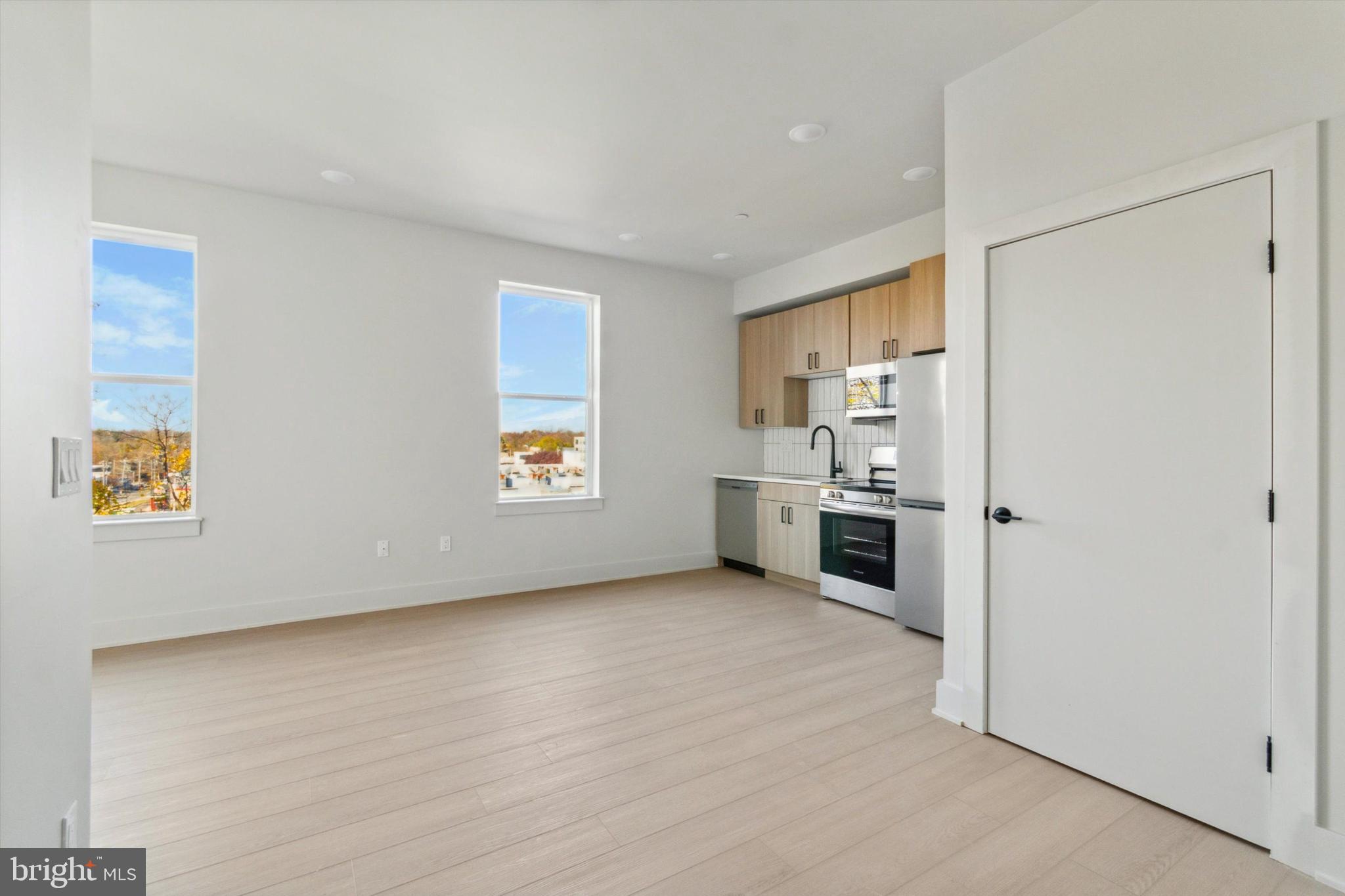 5521 Wayne Avenue, Unit 502 Philadelphia, PA 19144 - Photo 11 of 16 a view of a kitchen with a sink dishwasher and a refrigerator
