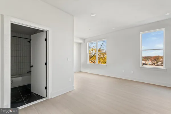 an empty room with windows and painted walls