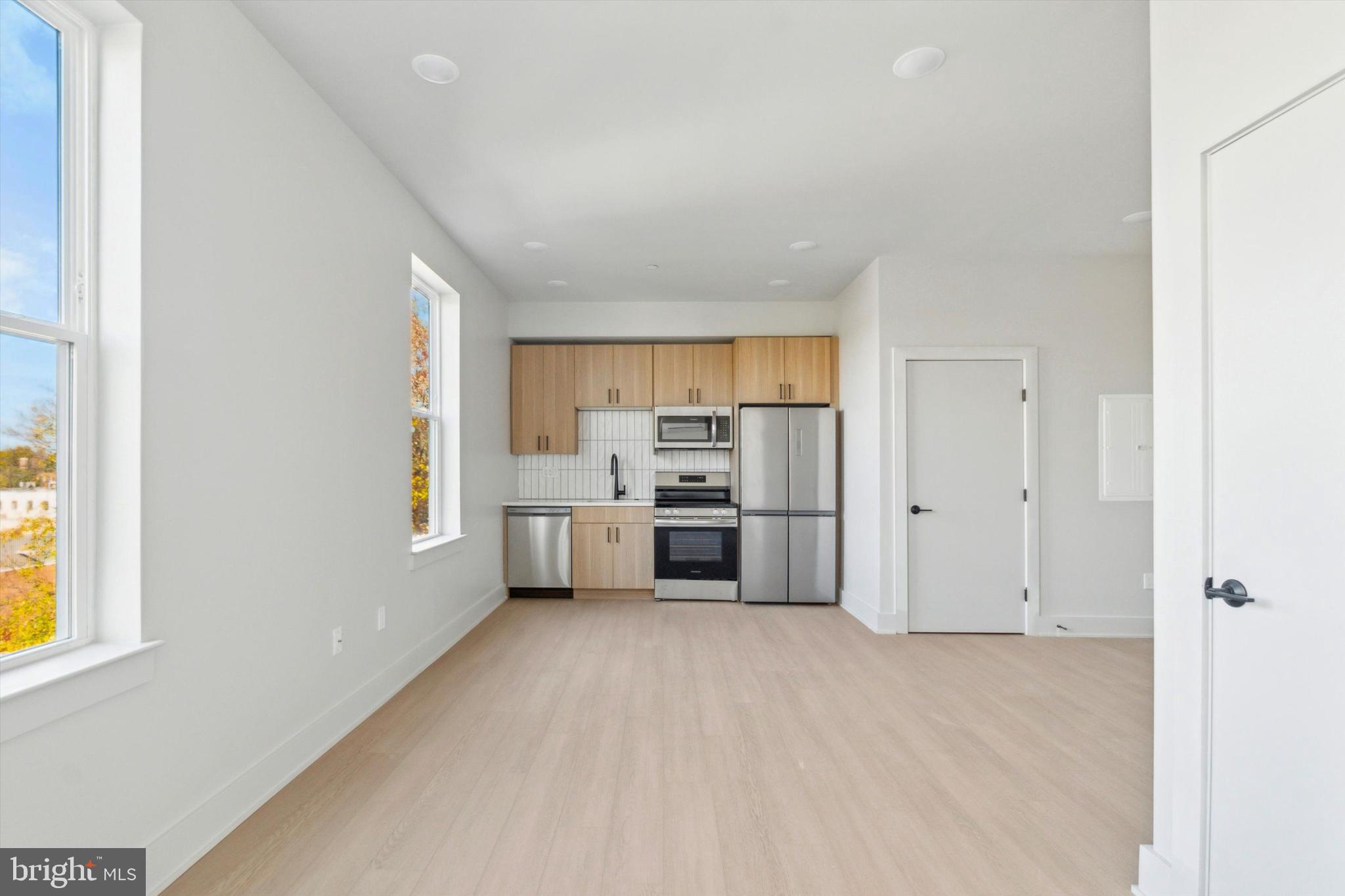 5521 Wayne Avenue, Unit 502 Philadelphia, PA 19144 - Photo 14 of 16 a view of a kitchen with a sink cabinets and a window