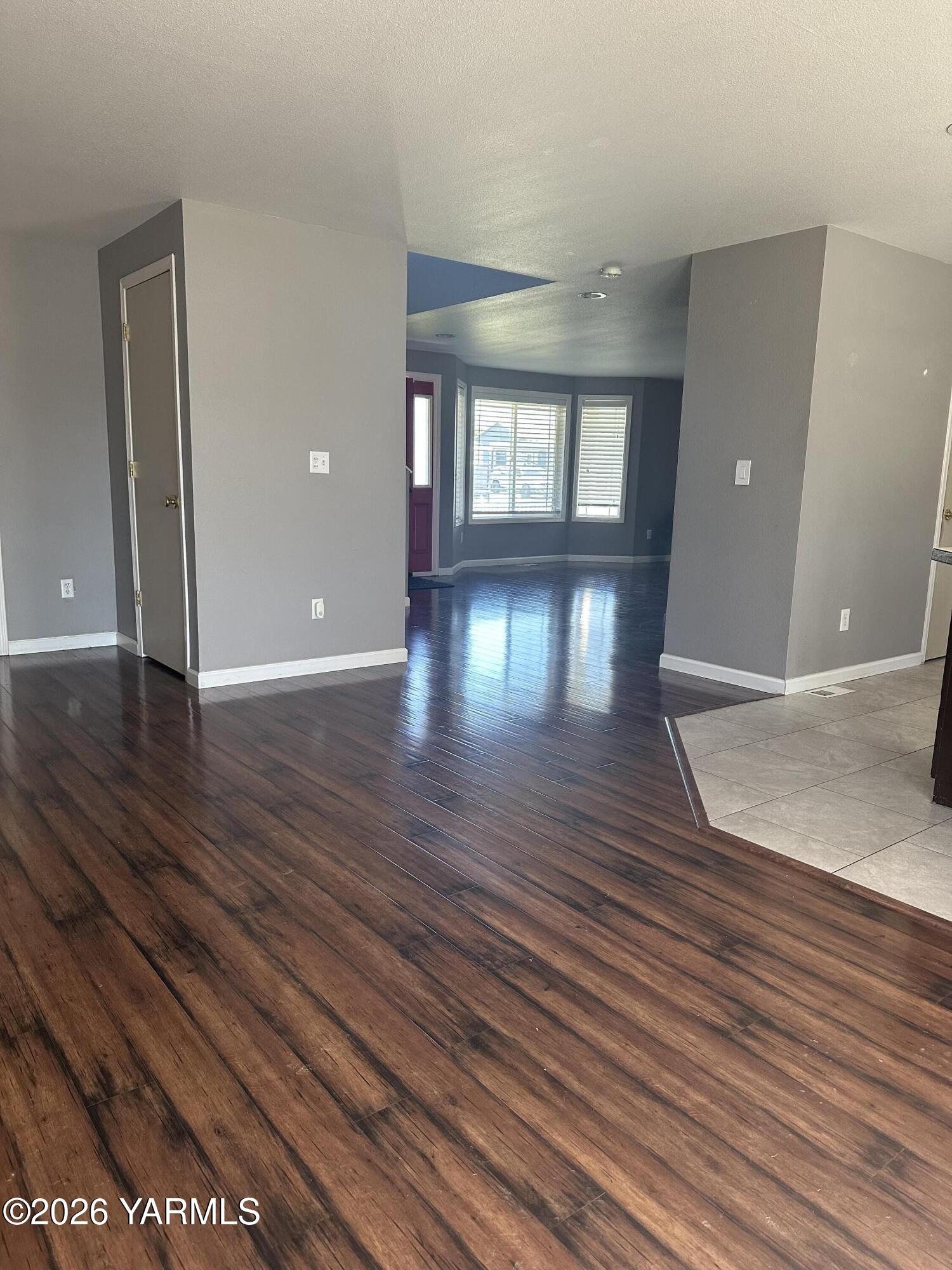 514 Cascade Avenue Moxee, WA 98936 - Photo 7 of 25 wooden floor in an empty room with a window