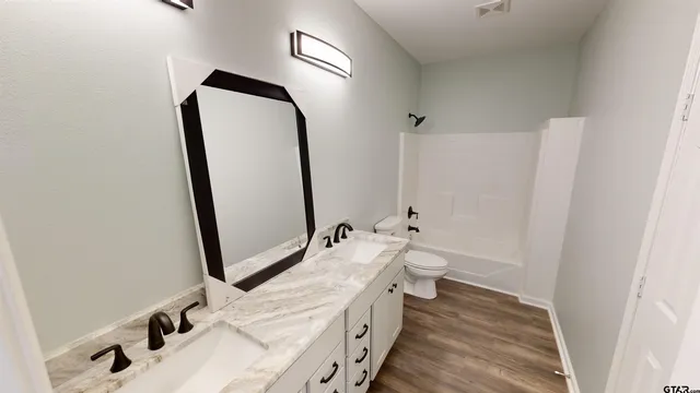 a bathroom with a bathtub sink and toilet