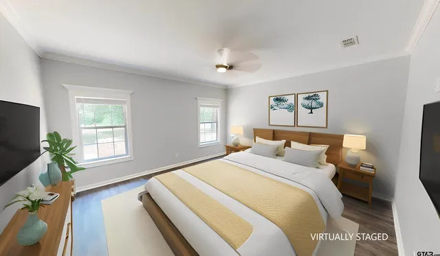 a bedroom with a balcony a bed and a flat screen tv