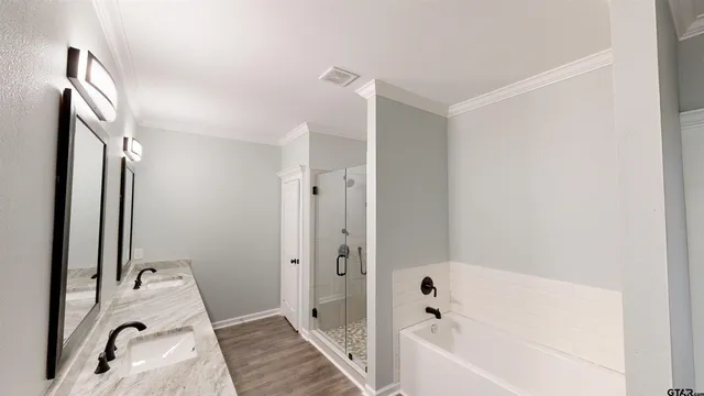 a bathroom with a tub sink and mirror