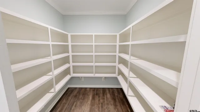a view of walk in closet with empty racks