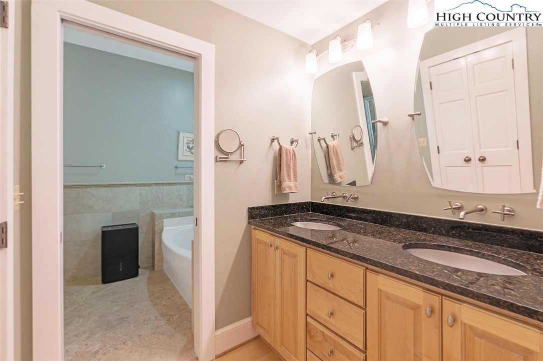 443 Echota Parkway, Unit 9B Boone, NC 28607 - Photo 19 of 43 a bathroom with a granite countertop sink and a mirror