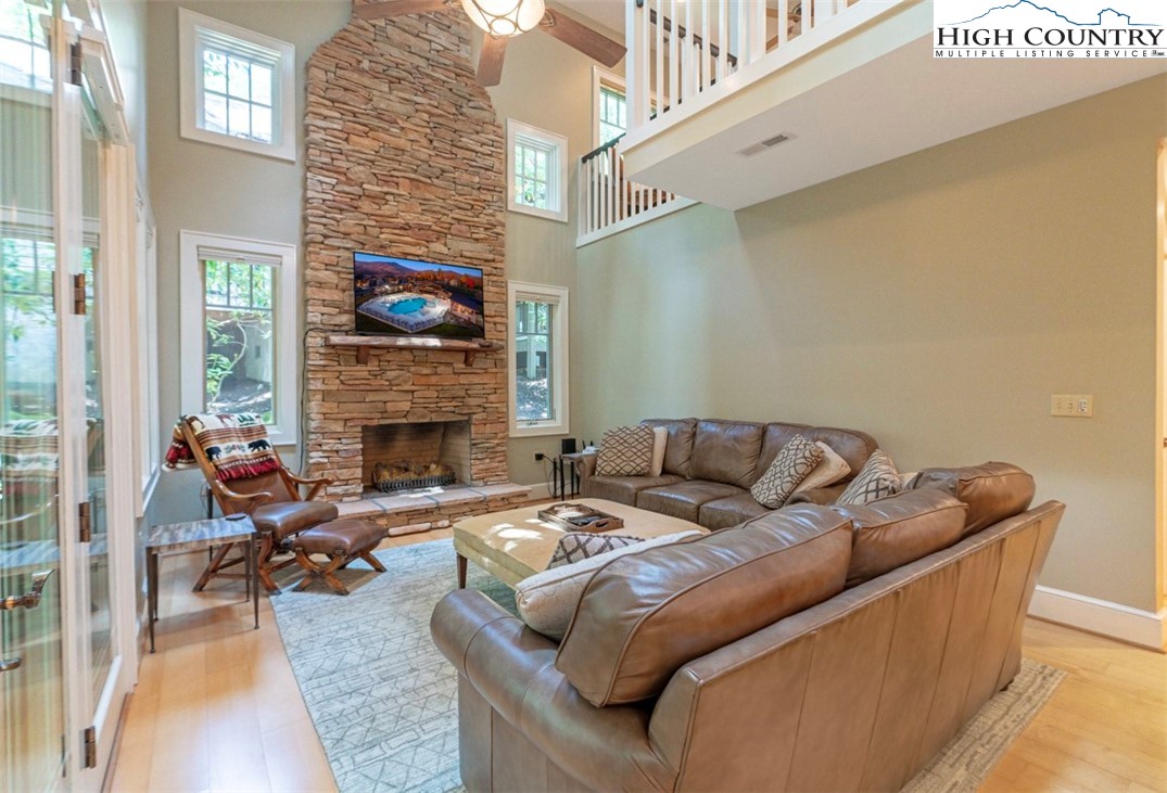 443 Echota Parkway, Unit 9B Boone, NC 28607 - Photo 2 of 43 a living room with furniture a fireplace and a flat screen tv