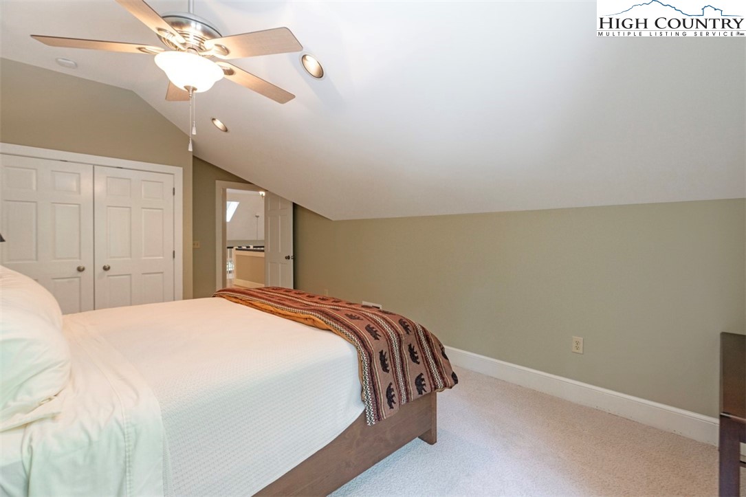 443 Echota Parkway, Unit 9B Boone, NC 28607 - Photo 26 of 43 a bedroom with a bed and a chandelier
