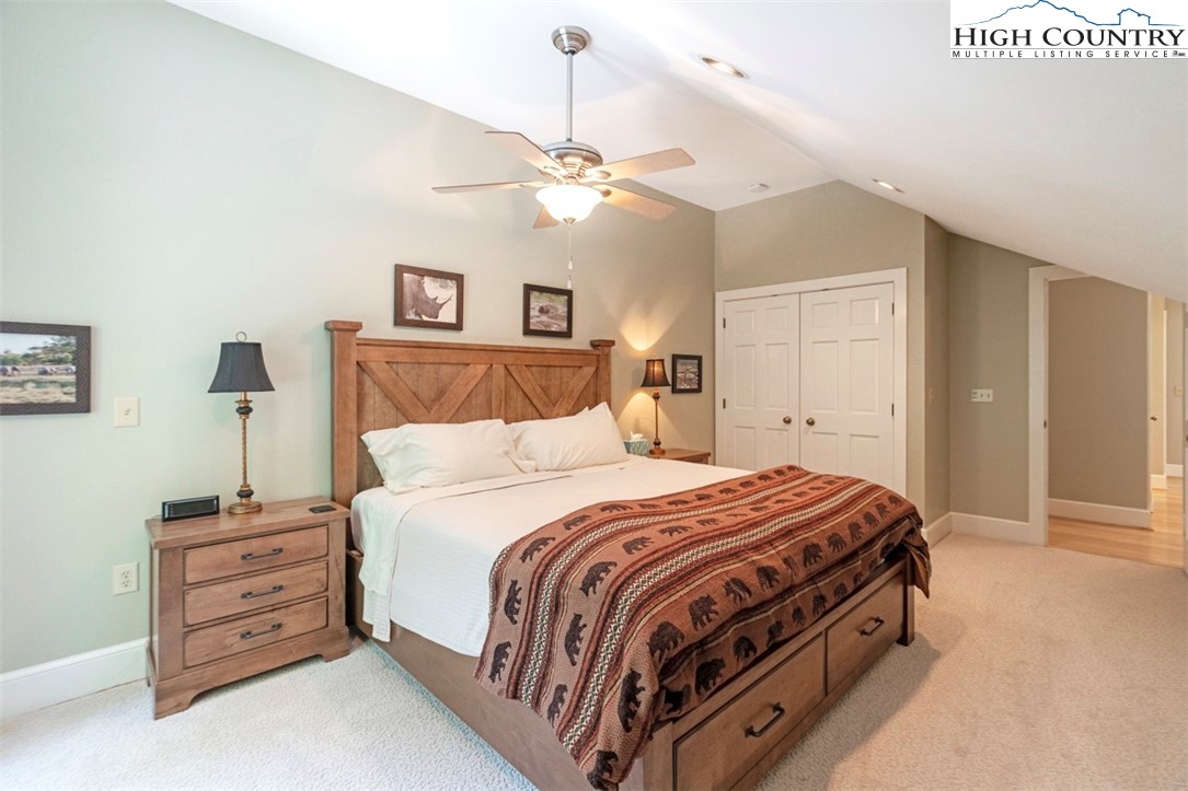 443 Echota Parkway, Unit 9B Boone, NC 28607 - Photo 27 of 43 a bedroom with a bed and a chandelier