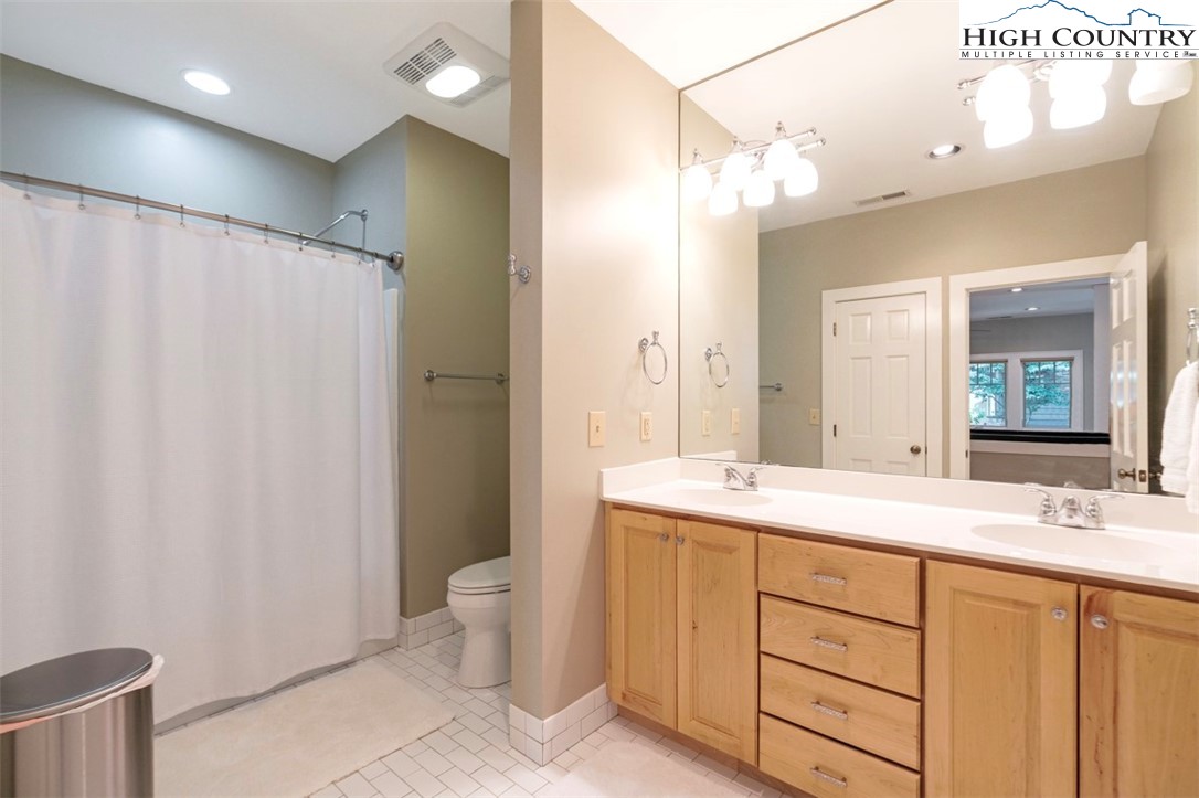 443 Echota Parkway, Unit 9B Boone, NC 28607 - Photo 28 of 43 a bathroom with a double vanity sink mirror and toilet