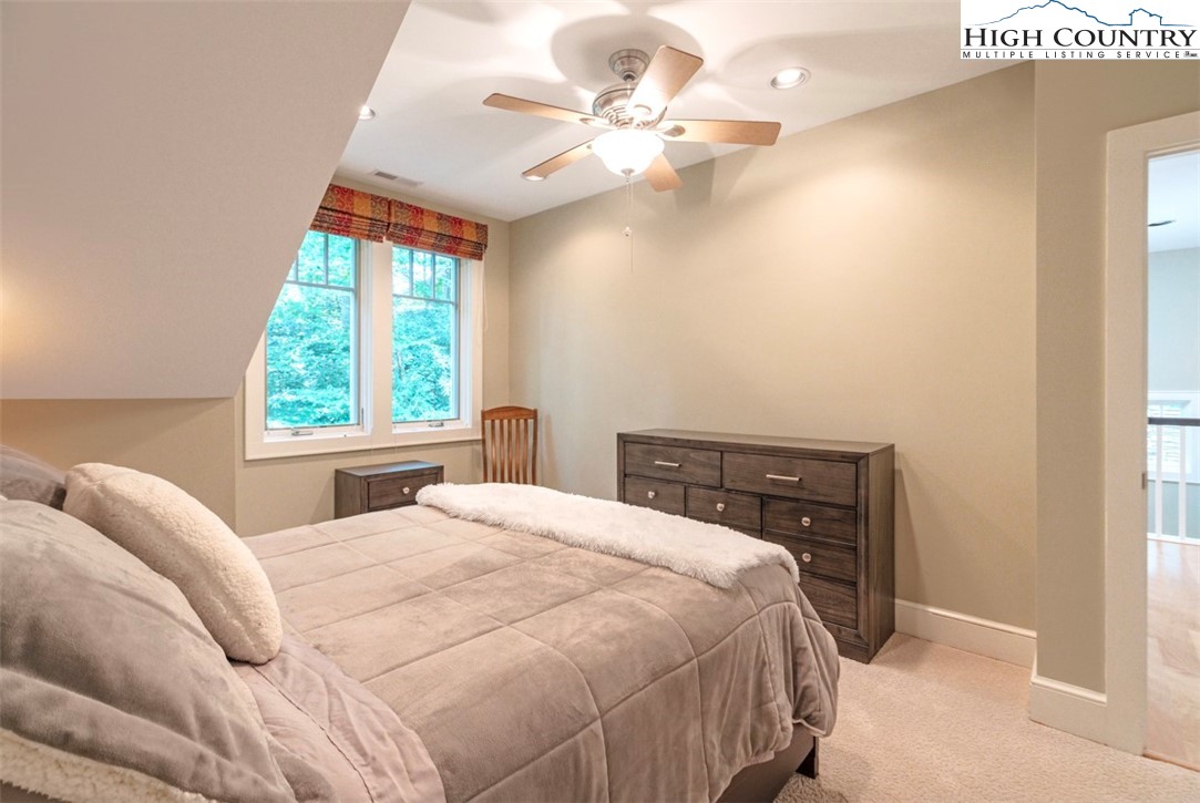 443 Echota Parkway, Unit 9B Boone, NC 28607 - Photo 30 of 43 a bedroom with a bed and a chandelier