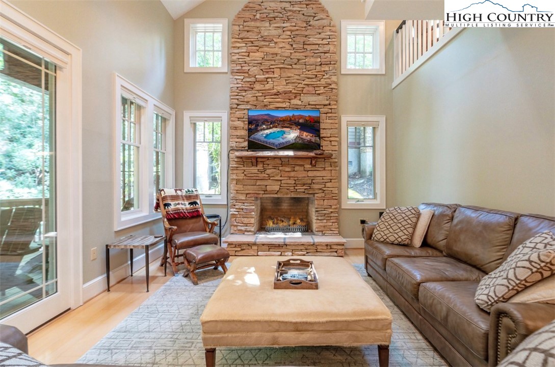 443 Echota Parkway, Unit 9B Boone, NC 28607 - Photo 3 of 43 a living room with furniture a fireplace and a flat screen tv