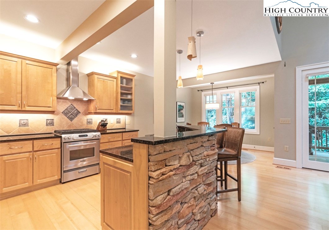 443 Echota Parkway, Unit 9B Boone, NC 28607 - Photo 6 of 43 a kitchen with stainless steel appliances granite countertop a stove top oven a sink dishwasher and cabinets with wooden floor