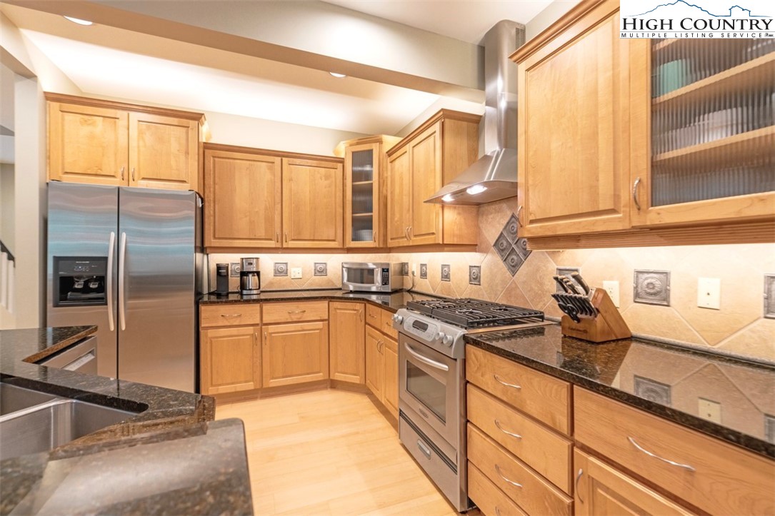 443 Echota Parkway, Unit 9B Boone, NC 28607 - Photo 9 of 43 a kitchen with granite countertop a sink stainless steel appliances and cabinets