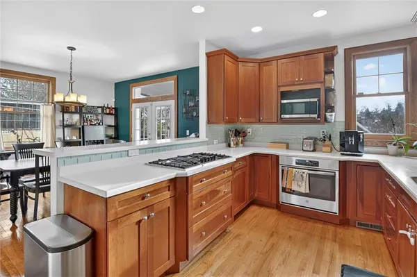 a kitchen with a stove a sink and a microwave